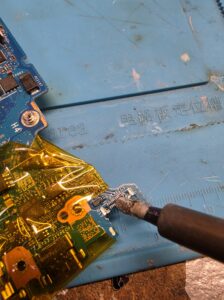 Preparing Lenovo laptop motherboard pads for Thunderbolt 4 port replacement