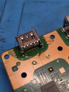 New HDMI port being soldered onto a PS5 motherboard